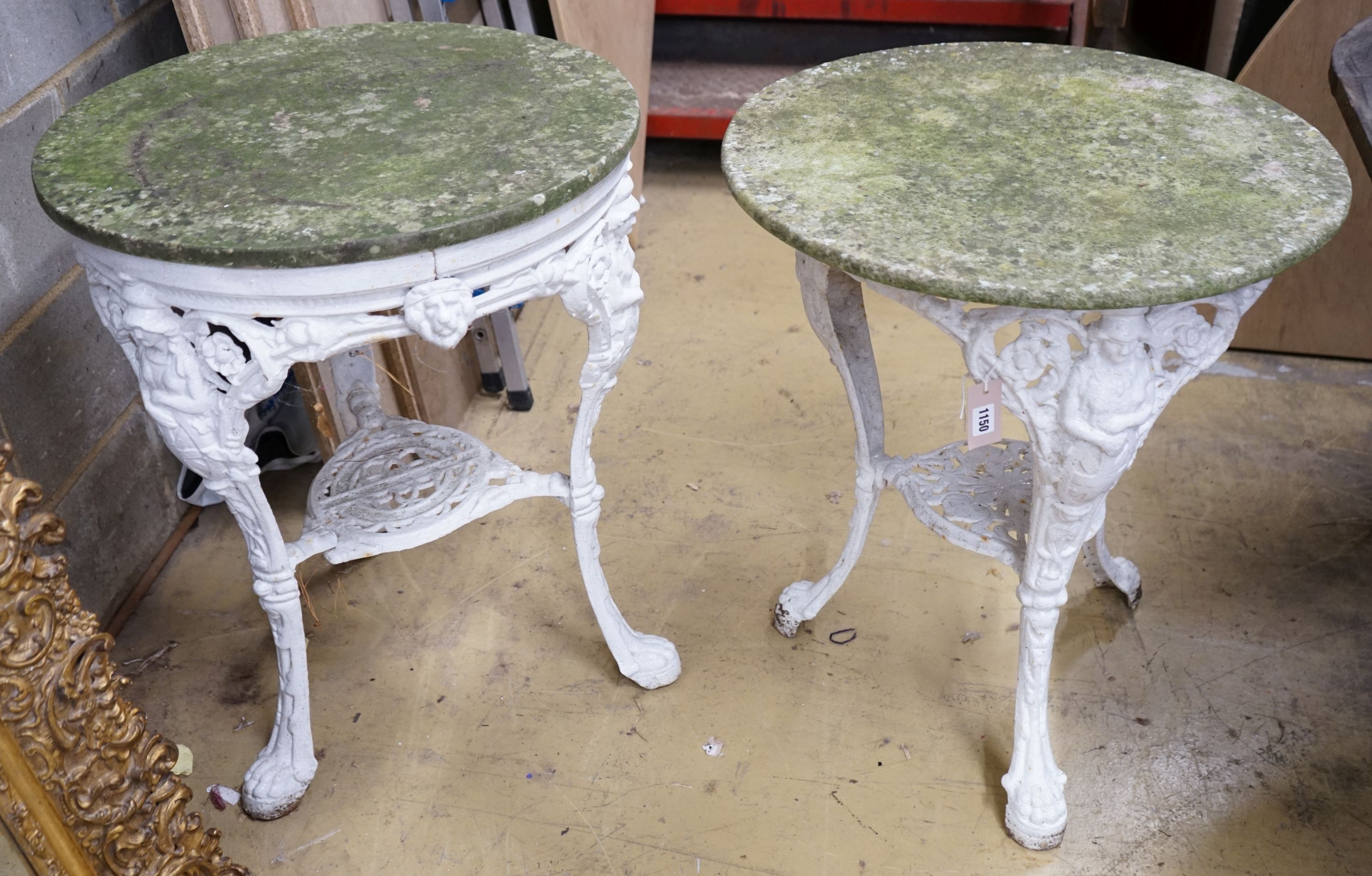 A pair of cast iron circular marble top tables, diameter 60cm, height 72cm